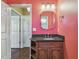 Pink bathroom with single vanity and mirror at 4338 14Th Street Cir, Palmetto, FL 34221