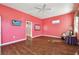 Spacious bedroom with hardwood floors and coral walls at 4338 14Th Street Cir, Palmetto, FL 34221