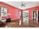 Large bedroom with hardwood floors and coral walls at 4338 14Th Street Cir, Palmetto, FL 34221