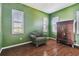 Green bedroom with hardwood floors and large windows at 4338 14Th Street Cir, Palmetto, FL 34221