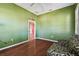 Green bedroom with hardwood floors and window shutters at 4338 14Th Street Cir, Palmetto, FL 34221