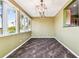 Elegant dining room with dark tile floors and a chandelier at 4338 14Th Street Cir, Palmetto, FL 34221