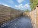 Long narrow backyard space with a wooden fence and landscaping at 4584 Country Manor Dr, Sarasota, FL 34233