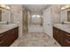 Elegant bathroom with double sinks, soaking tub, and walk-in shower at 4584 Country Manor Dr, Sarasota, FL 34233