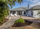 Home's back elevation showcasing patio, landscaping, and screened enclosure at 4584 Country Manor Dr, Sarasota, FL 34233