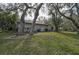 Private backyard with lush lawn and mature trees at 4655 Pine Green Trl # 24, Sarasota, FL 34241