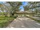 House exterior showcasing a light-green two-car garage and manicured lawn at 4655 Pine Green Trl # 24, Sarasota, FL 34241