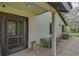 Front door entry with a screen door and stone pathway at 4655 Pine Green Trl # 24, Sarasota, FL 34241