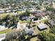 Aerial view of a residential area with houses and trees at 480 Azalea Rd, Venice, FL 34293