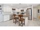 Modern kitchen featuring stainless steel appliances and an island with seating at 480 Azalea Rd, Venice, FL 34293