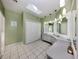 Large bathroom with double vanity and skylight at 4819 Greenleaf Rd, Sarasota, FL 34233