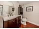 Powder room with dark brown vanity and toilet at 4819 Greenleaf Rd, Sarasota, FL 34233