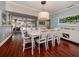 Dining room with large white table and access to backyard patio at 4819 Greenleaf Rd, Sarasota, FL 34233