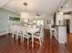 Bright dining room with white table and chairs, hardwood floors at 4819 Greenleaf Rd, Sarasota, FL 34233