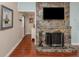 Stone fireplace with a TV above in the living room at 4819 Greenleaf Rd, Sarasota, FL 34233