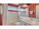 Charming bathroom with tub, shower and red accents at 4881 Flagstone Dr, Sarasota, FL 34238