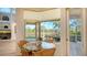 Bright breakfast nook with glass table and wicker chairs overlooks the patio at 4881 Flagstone Dr, Sarasota, FL 34238