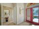 Light and bright entryway with red doors and wood floors at 4881 Flagstone Dr, Sarasota, FL 34238