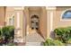 Front entry with double doors and arched entryway at 4881 Flagstone Dr, Sarasota, FL 34238