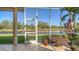 Peaceful screened patio with canal view and lush landscaping at 4881 Flagstone Dr, Sarasota, FL 34238