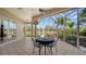 Spacious screened patio with table and chairs, overlooking the canal at 4881 Flagstone Dr, Sarasota, FL 34238