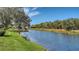 Serene canal view with lush landscaping and mature trees at 4881 Flagstone Dr, Sarasota, FL 34238