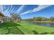 Beautiful backyard view of canal and lush green landscaping at 4881 Flagstone Dr, Sarasota, FL 34238