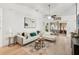 Living room featuring a white sectional sofa, wood-look floors and an open floor plan at 510 45Th E St, Bradenton, FL 34208