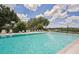 Community swimming pool with lounge chairs at 510 45Th E St, Bradenton, FL 34208