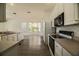 Bright kitchen with stainless steel appliances and a view into the adjacent dining area at 5154 51St W Ln, Bradenton, FL 34210