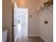 Bright laundry room with built-in shelving and view of living area at 5154 51St W Ln, Bradenton, FL 34210