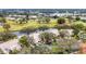 Scenic aerial view of property on the golf course, with lush landscaping and water features at 5432 Hampstead Heath # 26, Sarasota, FL 34235