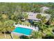 Aerial view showcases a private pool with lush greenery surrounding the outdoor living space at 5432 Hampstead Heath # 26, Sarasota, FL 34235