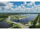 Aerial view of lake with surrounding roads and waterways at 5432 Hampstead Heath # 26, Sarasota, FL 34235