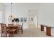 Bright dining room featuring neutral decor, a wood table with seating for six, and contemporary lighting at 5432 Hampstead Heath # 26, Sarasota, FL 34235