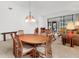 Cozy dining room featuring a wooden table, chairs, and an elegant hanging light fixture at 5432 Hampstead Heath # 26, Sarasota, FL 34235