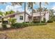 Light pink house with a two-car garage and a landscaped yard at 5432 Hampstead Heath # 26, Sarasota, FL 34235