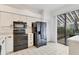 Kitchen with black appliances and white cabinets at 5432 Hampstead Heath # 26, Sarasota, FL 34235