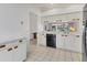 White kitchen with black appliances and wood accents at 5432 Hampstead Heath # 26, Sarasota, FL 34235