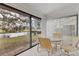 Sunroom with table and chairs overlooking water at 5432 Hampstead Heath # 26, Sarasota, FL 34235