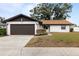 Single-story home with brown garage door and landscaped lawn at 5506 3Rd Avenue W Plz, Bradenton, FL 34209