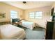 Bedroom with twin beds and wood dresser at 5507 28Th W St, Bradenton, FL 34207