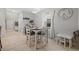 Small dining area with white table and chairs, suitable for a small Gathering at 5546 Appleton Shore Dr, Apollo Beach, FL 33572