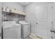 Laundry room with washer, dryer, and shelving at 5546 Appleton Shore Dr, Apollo Beach, FL 33572