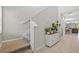 Modern staircase with carpeted steps and a white storage cabinet at 5546 Appleton Shore Dr, Apollo Beach, FL 33572