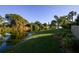 Backyard with canal view, lush landscaping, and a partial fence at 5671 Ashton Lake Dr # 3, Sarasota, FL 34231