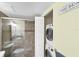 Bathroom with shower, sink, toilet and stacked washer/dryer at 5671 Ashton Lake Dr # 3, Sarasota, FL 34231