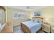 Bright bedroom with a queen bed, wooden frame, and ensuite bathroom at 5671 Ashton Lake Dr # 3, Sarasota, FL 34231