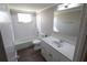 Bathroom with white vanity, tub, and wood-look floors at 5893 Welcome Rd # I-7, Bradenton, FL 34207