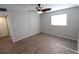 Bright bedroom with ceiling fan, wood-look floors, and ample closet space at 5893 Welcome Rd # I-7, Bradenton, FL 34207